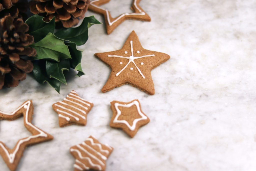 Iced gingerbread cookies with holly and pinecones
