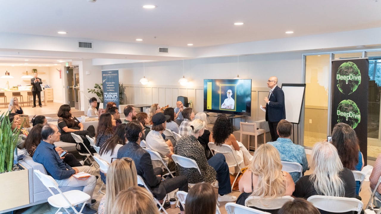 Speaker presents to seated audience at DeepDive event