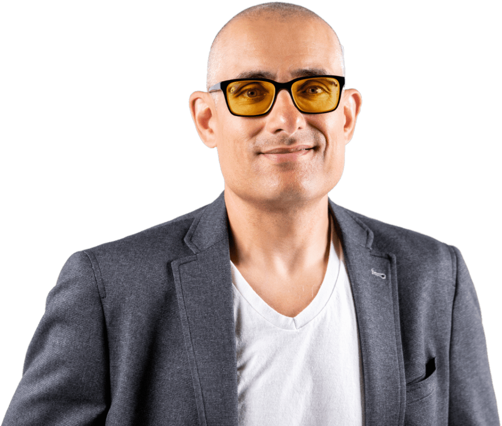 Smiling bald man wearing amber glasses and gray blazer